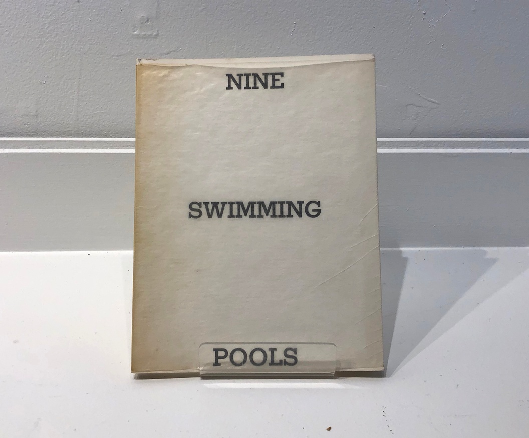 Nine Swimming Pools and a Broken Glass